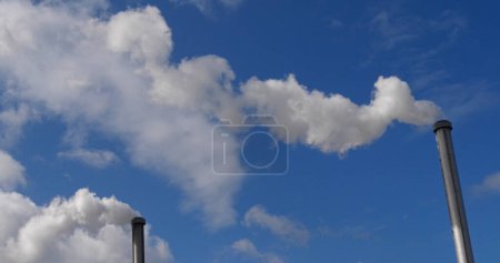 Photo for Steam of Water coming out of the Chimney of an Incinerator, Near Paris - Royalty Free Image