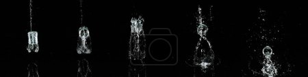 Foto de Vaso de agua rebotando y salpicando sobre fondo negro - Imagen libre de derechos