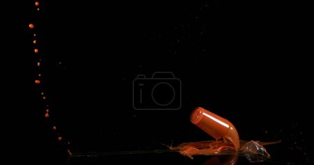 Photo for Glass of Tomato Juice Bouncing and Splashing on Black Background - Royalty Free Image