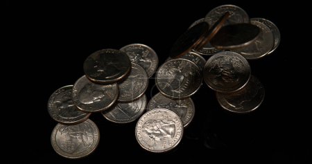 Photo for Quarter Dollar Coins Falling, Rolling and Sliding on Black Background - Royalty Free Image