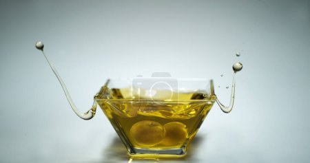 Photo for Green Olives, Olea europaea, Falling into a Jar - Royalty Free Image