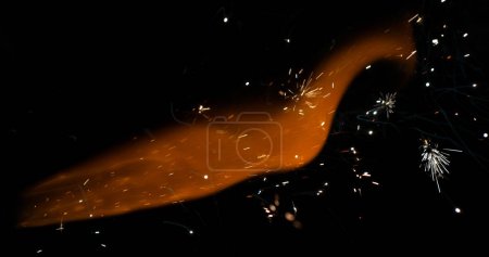 Photo for Flame and Sparkling Candle against black background - Royalty Free Image