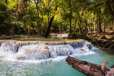 Photo for Fantasy majestic forest landscape with trees, river and waterfalls with sunlight and dreamy atmosphere, shot at Erawan Waterfall National Park, Thailand - Royalty Free Image