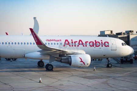 Photo for Abu Dhabi, UAE - December 2022: Air Arabia aircraft in the middle east. Air Arabia is an Emirati low-cost airline based in UAE - Royalty Free Image