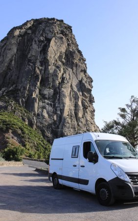 A camper van parked in a quiet natural environment, next to Roque Agando in La Gomera (Canary Islands)