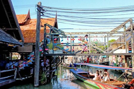 A floating market in Thailand showing colorful boats and traditional structures reflecting the local culture