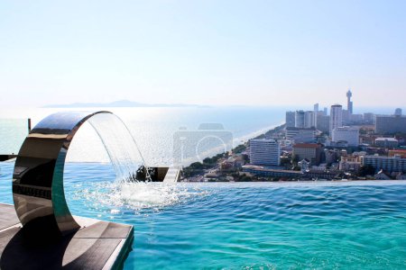 elegant infinity pool located on a rooftop, offering a panoramic view of the Pattaya, Thailand.