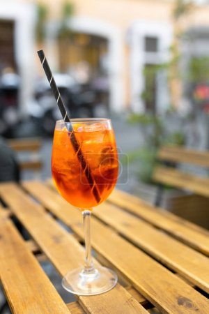 Photo for Typical italian alcoholic aperitif served in a bar. Alcoholic beverage based on table with ice cubes and oranges. - Royalty Free Image