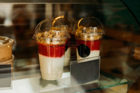 Photo for Granola with yogurts in the shop window of a cozy cafe. Tasty sweets. - Royalty Free Image