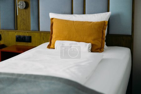 Téléchargez les photos : Chambre design moderne avec ameublement. Intérieur d'une chambre d'hôtel avec lit double. Lit vide avec oreiller et draps. - en image libre de droit