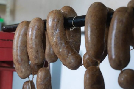 hanging cured sausage link  to dry the natural casing and curing process, smoking meat process