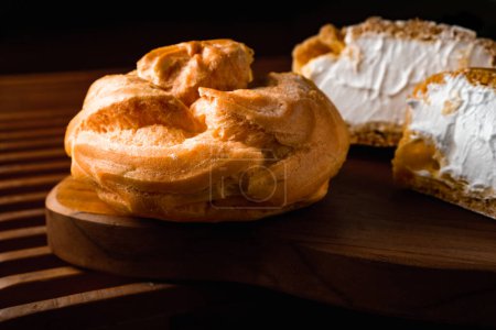 cream puff, a pastry filled with white cream, dark photography