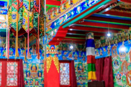 Buddhist temple interior featuring ornate decorations, statues of buddha, and traditional architecture. Serene atmosphere with intricate details, golden accents, religious and cultural artifacts Nepal