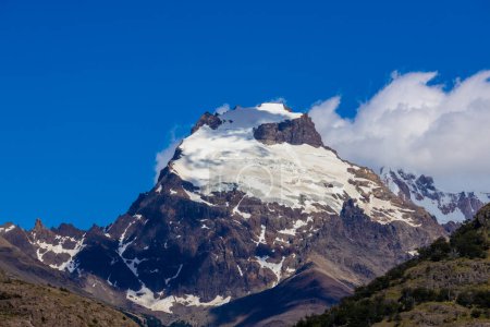 Patagonia mountains in El Chalten, Argentina. Monte Fitzroy and Cerro Torre summits granite walls above lake laguna Torre with icebergs floating ice and dark clouds nasty patagonian weather Andes mountain range