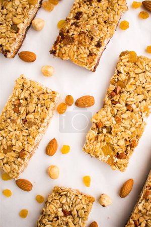Chocolate cereal bars with nuts, raisins, walnuts, hazelnut and seeds isolated on white background.  Granola bars with nuts and dried fruits.