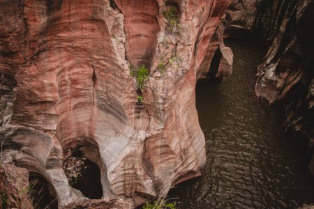 A mesmerizing close-up of Burks Luck Potholes in South Africa, revealing intricately eroded rock formations and serene water channels, making it a striking addition to any stock video collection.