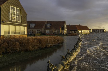 Photo for Sandbags protect against flooding in Frederikssund when the water level is at its highest on Friday afternoon, Denmark, Dec. 22, 2023 - Royalty Free Image