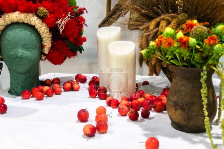 Photo for Decor in Ukrainian style. Red wreath on the head and candles on the table - Royalty Free Image