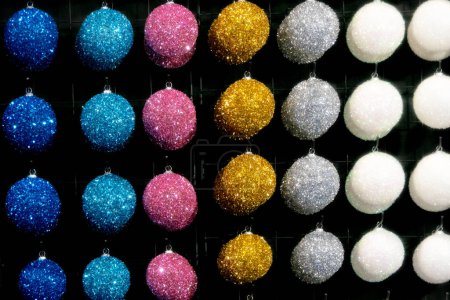 Photo for Multi-colored New Year's balls hang neatly in a row - Royalty Free Image