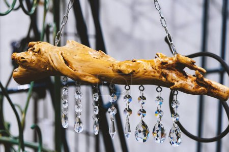Photo for Part of the interior decor. Tree root with shiny glass stones hanging on a chain - Royalty Free Image