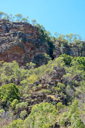 Rugged Outback scenery featuring rocky outcrops and dense bushland. Perfect for travel, nature, and adventure projects highlighting Australia's wild beauty