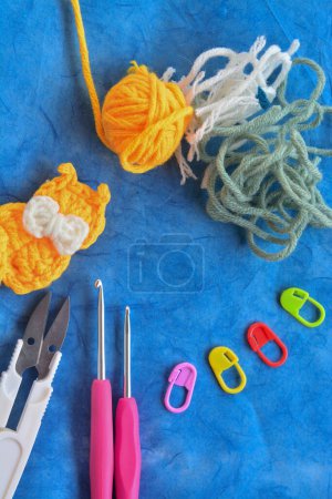 "Crochet Kit: Hooks, Scissors, and More on Blue Background"