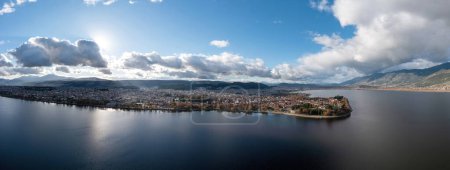 Photo for Greece, Ioannina  city. Aerial panoramic drone view of Giannena and Lake Pamvotis, cloudy blue sky. Epirus. - Royalty Free Image