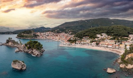 Photo for Greece Parga, destination Epirus. Drone aerial view of coastal city and Panagia chapel and islet, nature, mountain, cloudy afternoon sky background. - Royalty Free Image