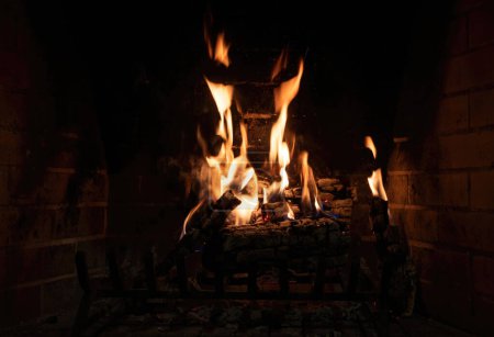 Photo for Fireplace with fire burning on logs - Royalty Free Image