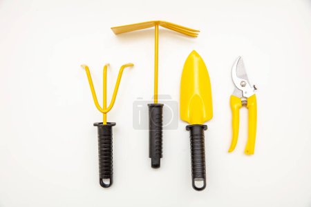Photo for Gardening yellow set. Garden tools isolated on white background, view from above - Royalty Free Image