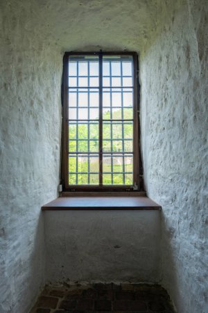 Heidelberg castle, Friedrich Building close window with indoors sill between whitewashed wall, Germany. German medieval sightseeing. Vertical