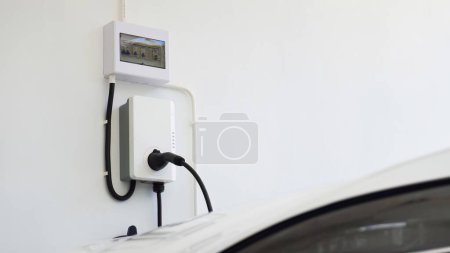 Home garage charging electric vehicle  in concept of green energy and eco power produced 