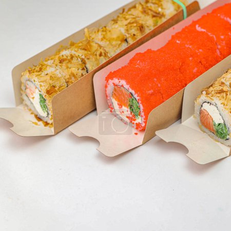 A photo showcasing three different types of food - a sandwich, a burrito, and a fruit roll, all neatly wrapped in paper.