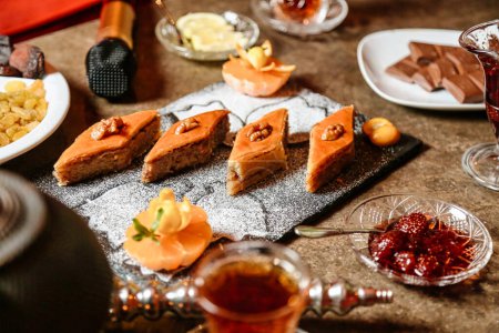A table filled with a variety of desserts and a selection of drinks, offering an indulgent feast for the eyes and taste buds.