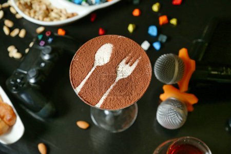 A cake adorned with a fork and spoon on top, ready to be served.