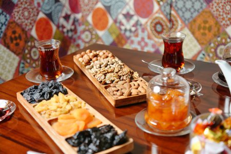 A wooden table featuring a variety of food trays filled with delicious dishes.