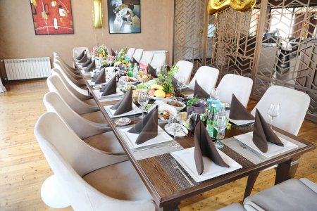 A large table surrounded by numerous chairs, offering ample space for gatherings and meetings.