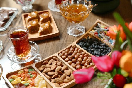 Ein Holztisch mit verschiedenen Tabletts mit Speisen und Getränken für ein Treffen oder eine Party.
