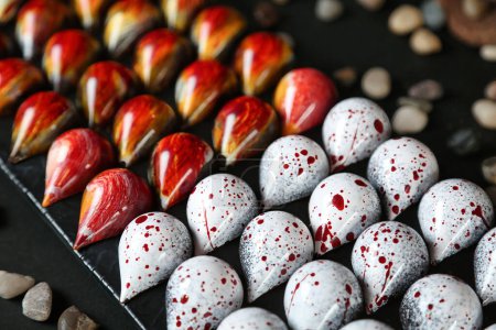 A tray filled with various red and white candies neatly arranged.