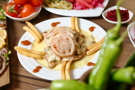 A mouth-watering plate of food featuring perfectly cooked meat and golden french fries.