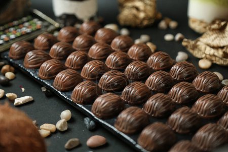 A table covered with a wide variety of chocolates and nuts, creating a tempting display.