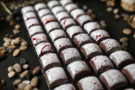 A close-up photograph showcasing an array of delicious desserts neatly arranged on a tray.