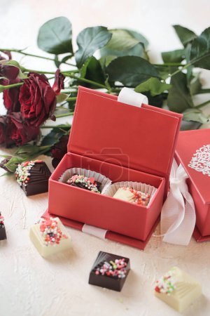 Photo for A red box brimming with a diverse assortment of chocolates creates a delightful display. - Royalty Free Image