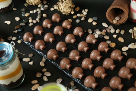 A variety of chocolate covered desserts are beautifully arranged on a table.