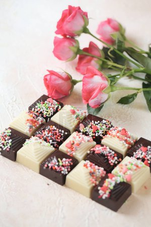 A variety of chocolates topped with vibrant sprinkles, creating a visually appealing and tasty treat.