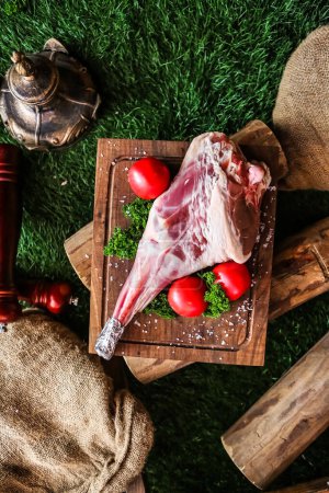 A juicy, uncooked ribeye steak sits on a wooden cutting board, waiting to be prepared.