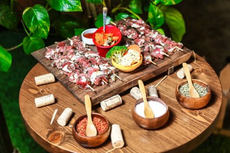 A wooden table is filled with an assortment of delicious food bowls.