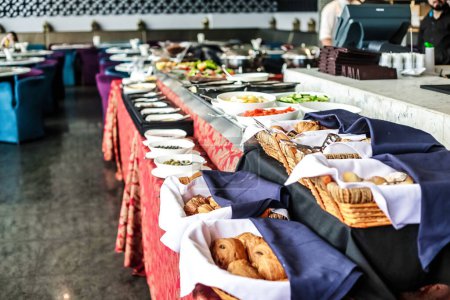 A buffet line featuring a wide selection of different food items prepared for self-service.