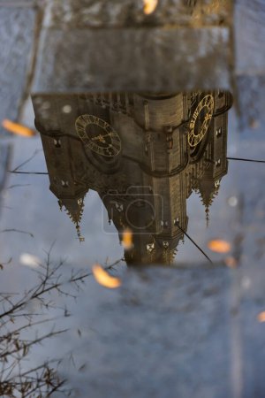 Photo for Reflection of the highest part of the clock tower Rainy winter day. Ghent, Belgium - Royalty Free Image