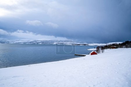 Photo for Snowy coastline and fisherman house at mortenhals town in tromso, norway - Royalty Free Image